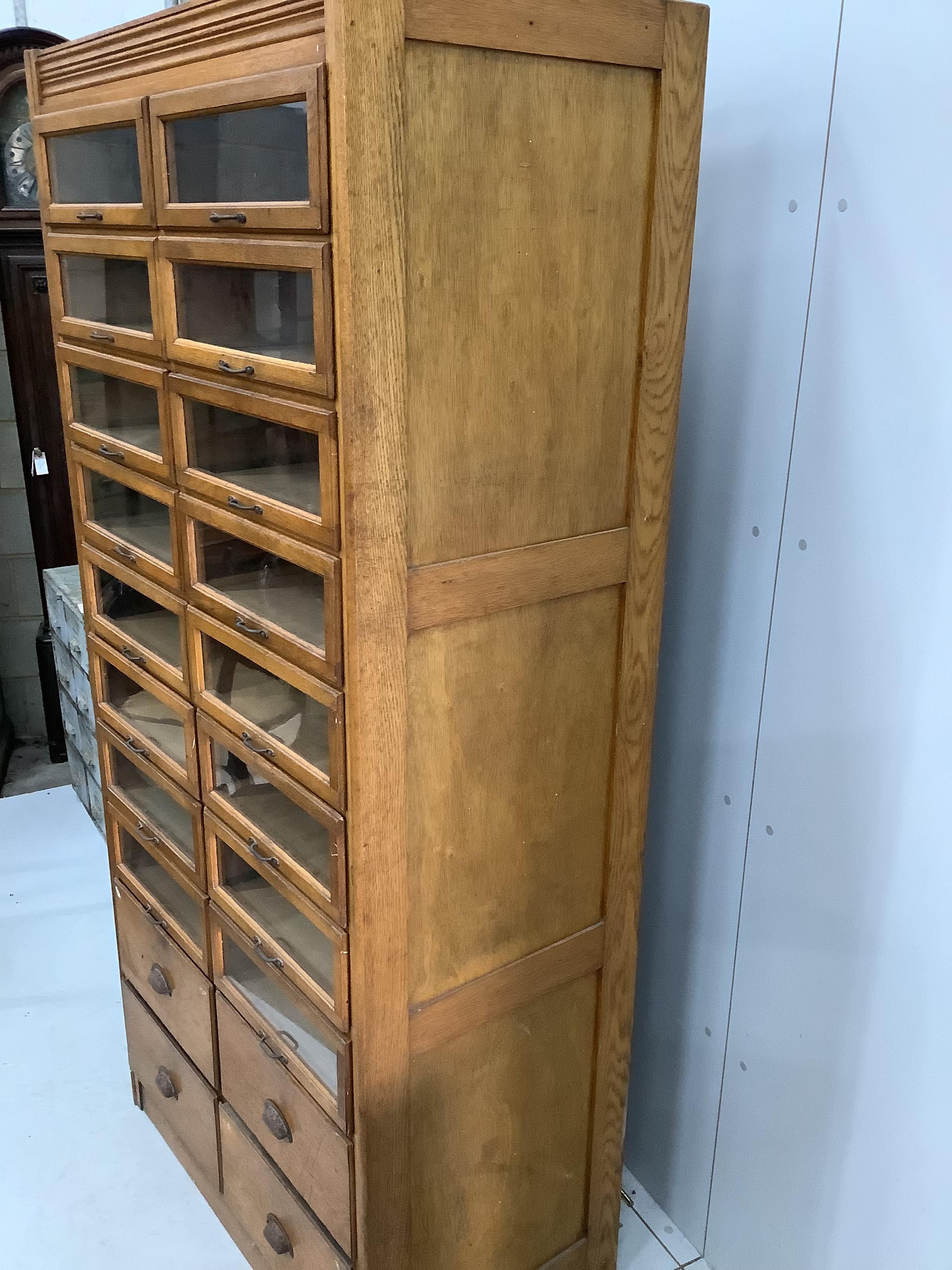 A mid century oak twenty drawer haberdashery cabinet, width 92cm, depth 51cm, height 197cm